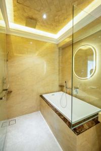 a bathroom with a tub and a glass shower at Ritz Residence @ Imago Loft B 7th Floor in Kota Kinabalu