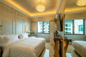 a bedroom with a bed and a desk and windows at Ritz Residence @ Imago Loft B 7th Floor in Kota Kinabalu +37 photos