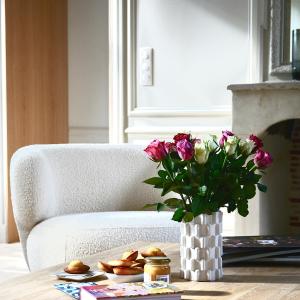 a vase of flowers on a table with a chair at Bayeux, Normandy, Private Mansion, 17th-18th century, in the city in Bayeux