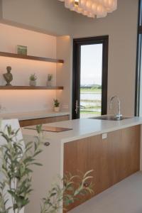 a kitchen with a sink and a large window at Golden Harvest Homestay in Toucheng