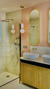 a bathroom with two sinks and a shower at Bayeux, Normandy, Private Mansion, 17th-18th century, in the city in Bayeux