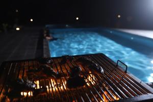 a grill sitting next to a swimming pool at Green Nest Yala in Hambantota