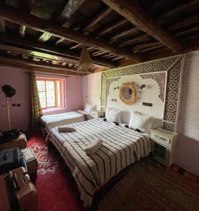 a bedroom with two beds in a room at Berber Family Lodge in Imlil