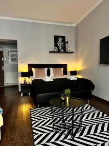 a living room with a bed and a coffee table at Leo Apartments Old Town in Krakow