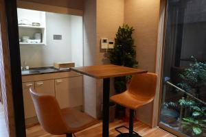 a small kitchen with a table and two chairs at Kyoto-cocoro house in Kyoto