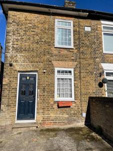 a brick house with a blue door and two windows at Luxury Spacious 2-Bed House in Brentwood Essex in Brentwood