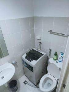 a small bathroom with a toilet and a sink at Ranj Staycation @ Sea Residences Pasay in Manila