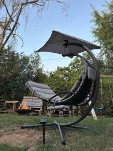 a swing set with an umbrella in a park at Studio Strasbourg avec jardin in Strasbourg