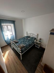 a bedroom with a bed and a window at Casa das Sapinhas (Ourém/Fátima) in Soutaria +11 photos