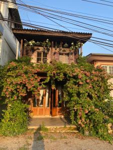 a house with flowers in front of it at Baan Somlim Homestay in Sukhothai