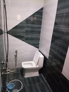 a bathroom with a toilet and a shower at Alif serviced Apartment for Families and Executives in Tambaram