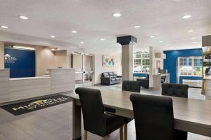 a kitchen and dining room with a table and chairs at Microtel Inn & Suites by Wyndham Florence/Cincinnati Airpo in Florence