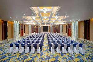 a large room with chairs and a stage in it at Ramada Plaza by Wyndham Chongqing West in Dazu