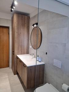 a bathroom with a sink and a mirror at Apartments Maestral in Malinska