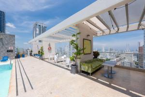 a rooftop patio with a couch and a pool on a building at Hampton by Hilton Cartagena in Cartagena de Indias +68 photos