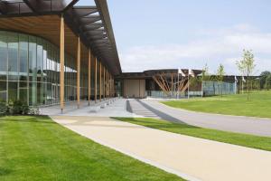 an external view of a building with a grass field at Hilton at St George's Park in Burton upon Trent