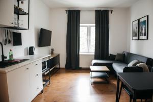 a living room with a couch and a table at Macao Apartmani in Vinkovci