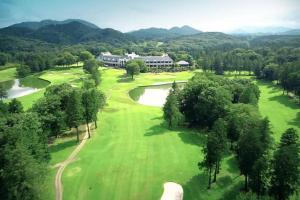 an aerial view of a golf course with a house at FOREST HOUSE NIKKO in Nikko