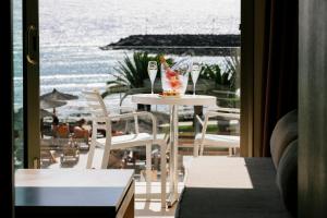 a table and chairs with a view of the ocean at HD Beach Resort in Costa Teguise