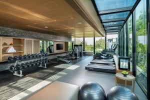 a gym with a lot of exercise equipment and windows at Hilton Yala Resort in Yala