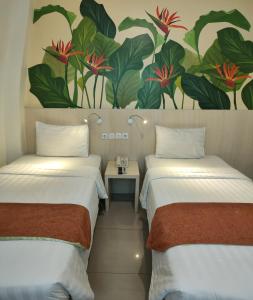 Postel nebo postele na pokoji v ubytování D'Bamboo Suites