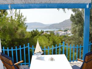 a table with a toy sailboat on top of a blue fence at Villa Bellina in Pefki