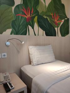 Postel nebo postele na pokoji v ubytování D'Bamboo Suites