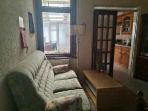 a living room with a couch and a table and a window at Double Room available- London Seven Kings Seven Kings Train Station in Seven Kings +4 photos