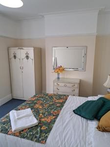 a bedroom with a bed and a dresser and a window at Double Room available- London Seven Kings Seven Kings Train Station in Seven Kings