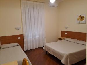 A bed or beds in a room at Hotel Villa Robinia