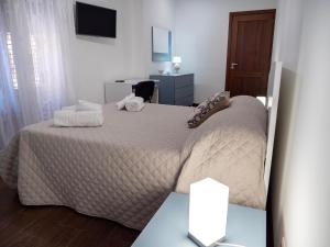 a bedroom with a bed and a desk at La Torre in Santo Stefano di Camastra