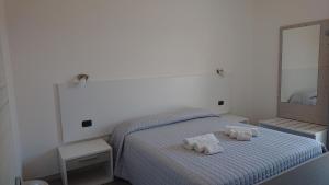 Posteľ alebo postele v izbe v ubytovaní Hotel Ogliastra