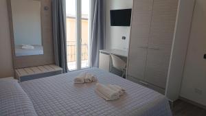 Posteľ alebo postele v izbe v ubytovaní Hotel Ogliastra
