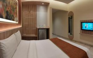 Postel nebo postele na pokoji v ubytování D'Bamboo Suites
