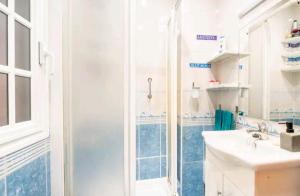 a bathroom with a shower and a sink at Ikigai House in Seville