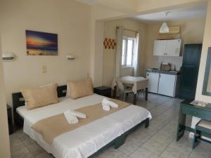 a bedroom with a large bed with towels on it at Villa Teozenia in Achladies