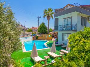 a villa with a swimming pool and a house at Nehir Apart Hotel in Fethiye +57 photos
