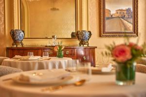 a dining room with two tables and a mirror at Palacio Ca Sa Galesa in Palma de Mallorca