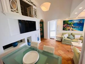 a living room with a glass table and a couch at LUXURY House in VILLA POMPEIANA Via Camerelle con Terrazza Vista Mare in Capri
