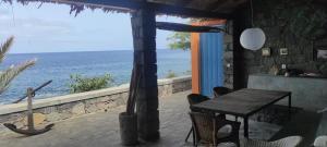 a room with a table and a view of the ocean at Casa Praia Tarrafal de Monte Trigo in Seladinha