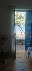 a door to a room with a view of the ocean at Casa Praia Tarrafal de Monte Trigo in Seladinha