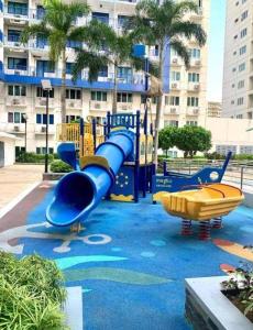 a playground in front of a large building at Ranj Staycation @ Sea Residences Pasay in Manila