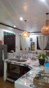 a kitchen with a sink and a counter top at JML Private 2-Double Room in General Luna