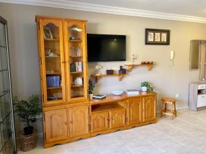 a wooden entertainment center with a television in a room at Apartamento Dulce Vista in Poris de Abona