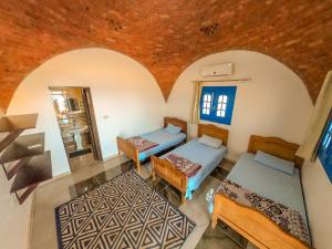 an overhead view of a room with two beds and a mirror at Aladdin Camp in Nuweiba