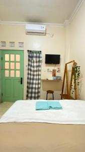 a bedroom with a bed with a green door and a desk at Et Malio Stay & Travel in Sentool