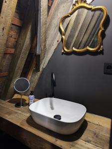 a bathroom with a white sink on a wooden counter at Rooftop apartment with 60m terrace overlooking the cathedral in Antwerp