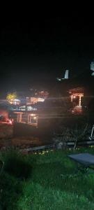 a view of a city at night with lights at Guest House Shina in Omalo