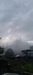 a view of a foggy mountain with a view of a valley at Guest House Shina in Omalo