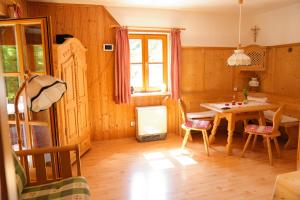 a dining room with a table and a table and chairs at Haus Zirbennest in Zlem